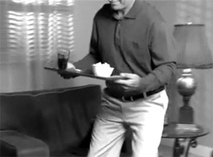 Man carrying a tray, exaggerating how much it's slipping and falling